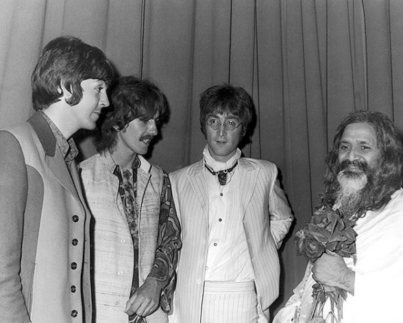 The four Beatles backstage with Maharishi.