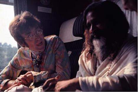 John Lennon and Maharishi chatting in the train.