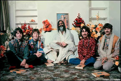 The Beatles after their initiation to TM with Maharishi in front of them the book "Science of Being and Art of Living: Transcendental Meditation".